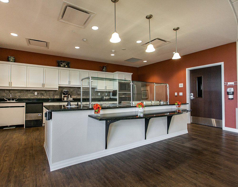 Hawkeye Care Center kitchen area with white cabinets and food serving area on a long island counter